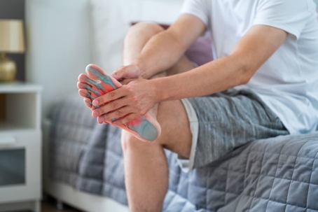 man holding foot with x-ray view of bones